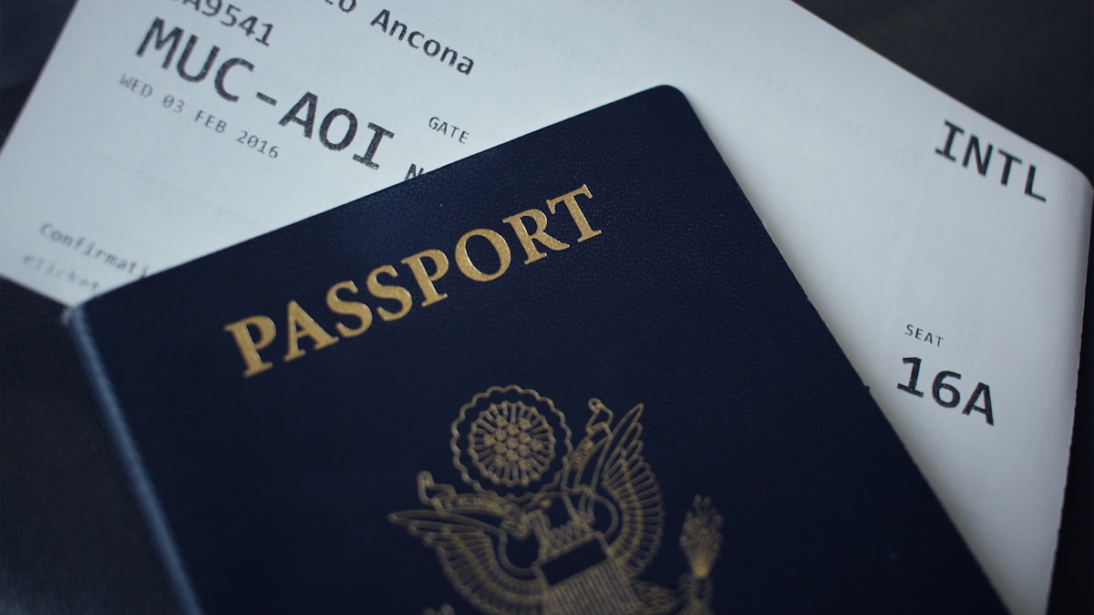 A passport resting on top of two printed boarding passes